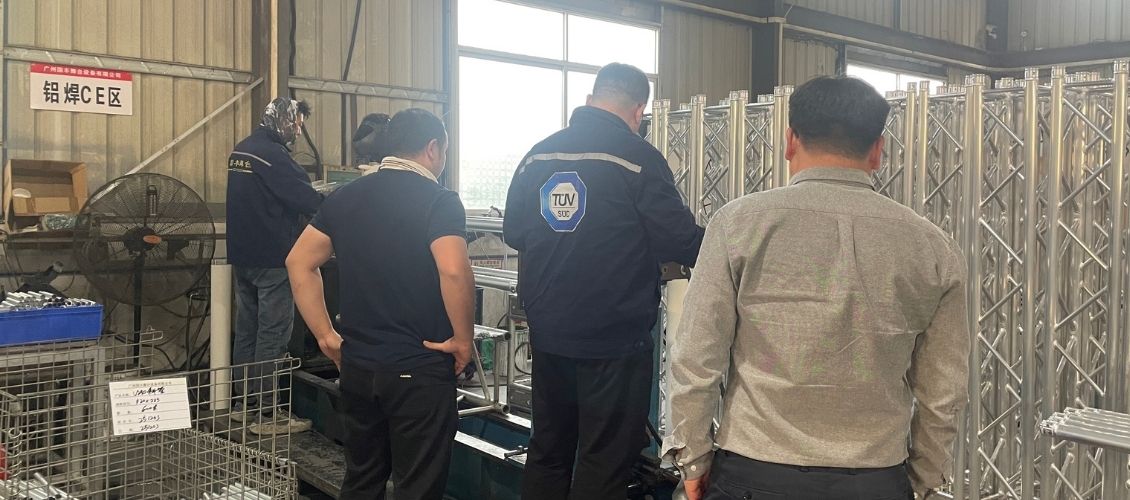TUV SUD auditor guiding GF-Truss welders on aluminum truss welding standards